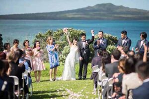 Rangitoto in background. Happy couple on wedding day